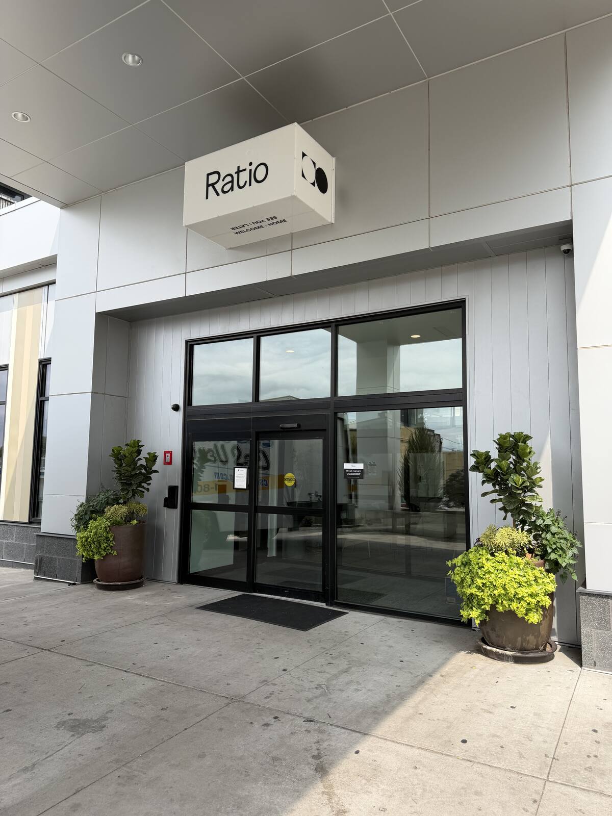 Planters and entry plantings at a commercial building door