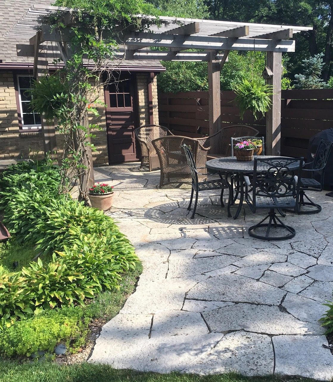 Cedar pergola over a flagstone patio